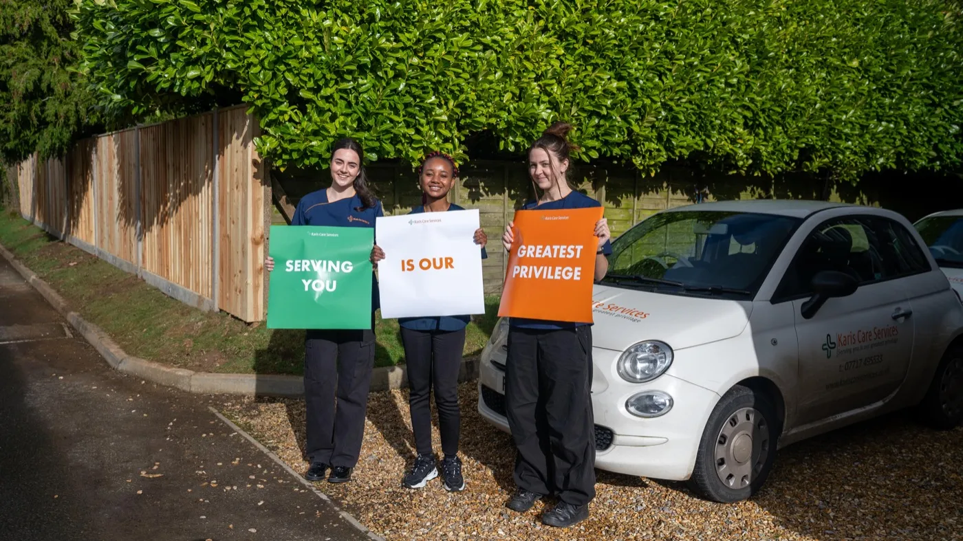 The Karis Care Services team outside their office at The Stone Yard, Alton Lane, Four Marks, with a branded company car