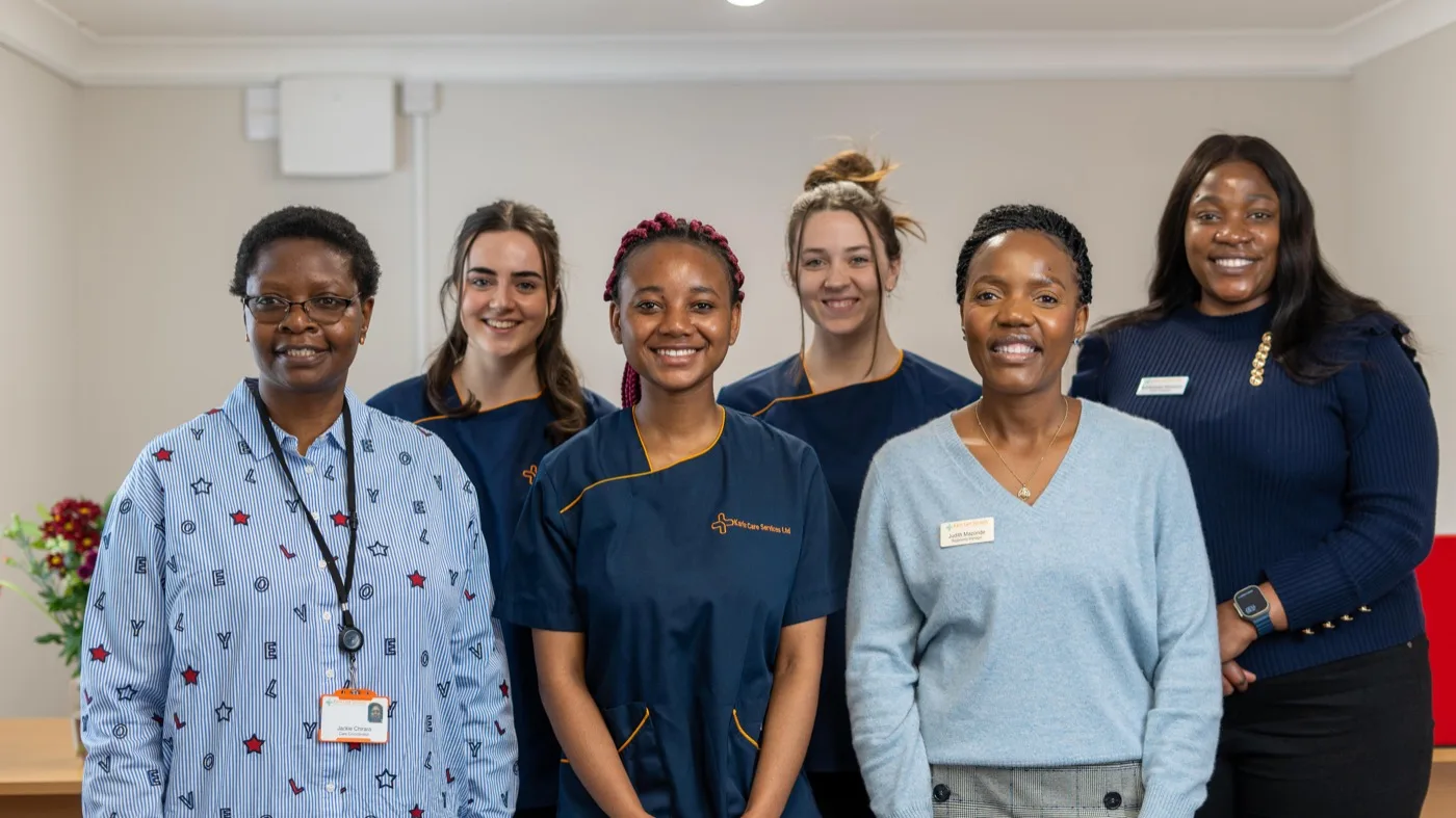 The Karis Care Services team in navy branded uniforms at their Four Marks office in Alton, Hampshire